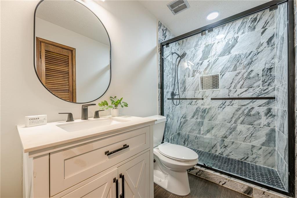 4147 Scofield Place Stone Mountain, GA 30083 - Photo 32 of 56 a bathroom with a sink vanity mirror and toilet