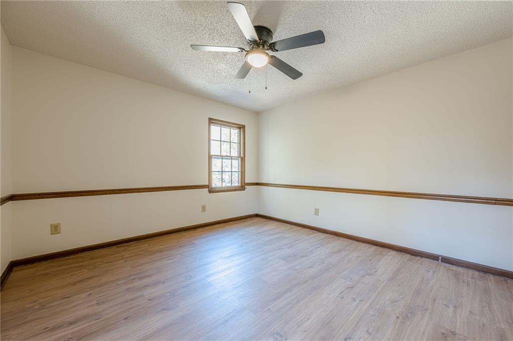 4147 Scofield Place Stone Mountain, GA 30083 - Photo 41 of 56 a view of an empty room with wooden floor and a window