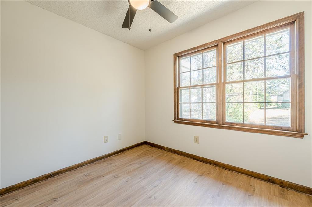 4147 Scofield Place Stone Mountain, GA 30083 - Photo 48 of 56 an empty room with wooden floor and windows