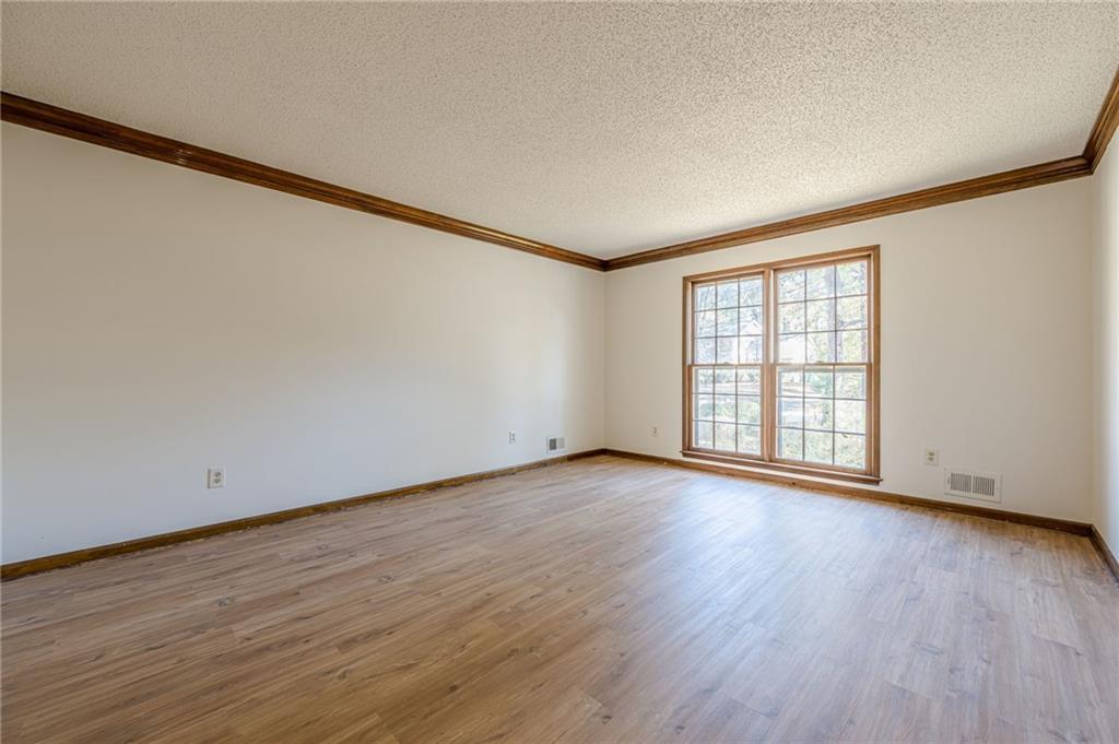 4147 Scofield Place Stone Mountain, GA 30083 - Photo 9 of 56 a view of an empty room with wooden floor and a window
