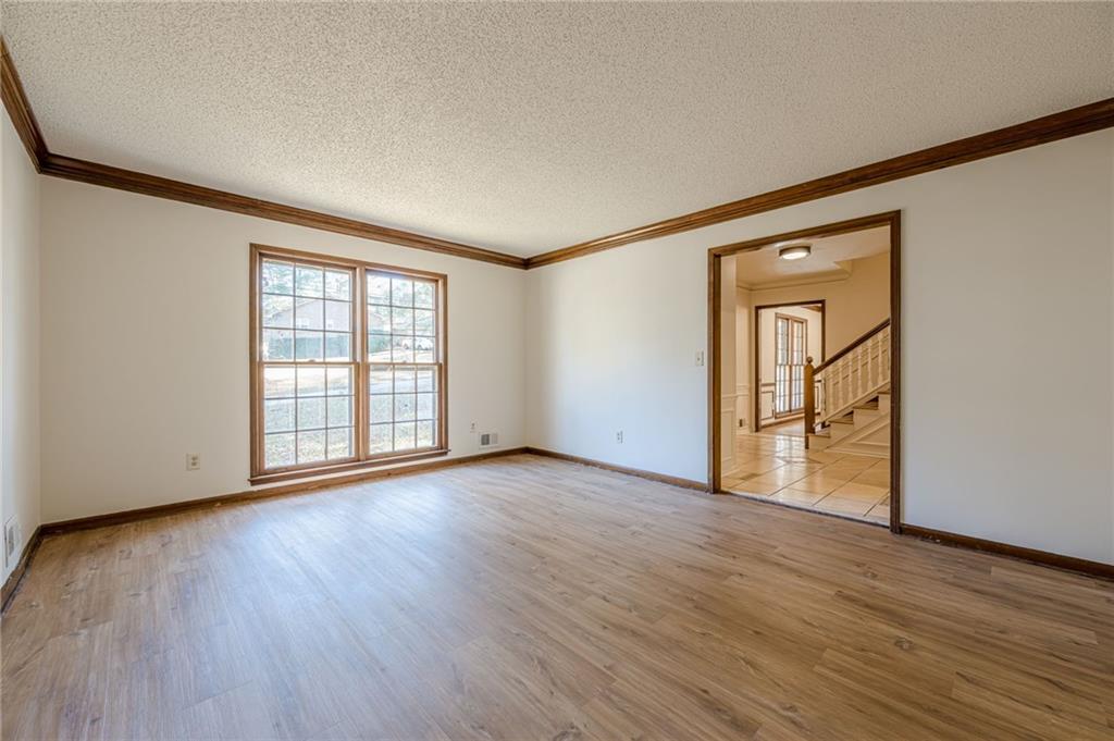4147 Scofield Place Stone Mountain, GA 30083 - Photo 10 of 56 a view of an empty room with wooden floor and a window