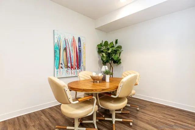 a dining room with furniture and wooden floor