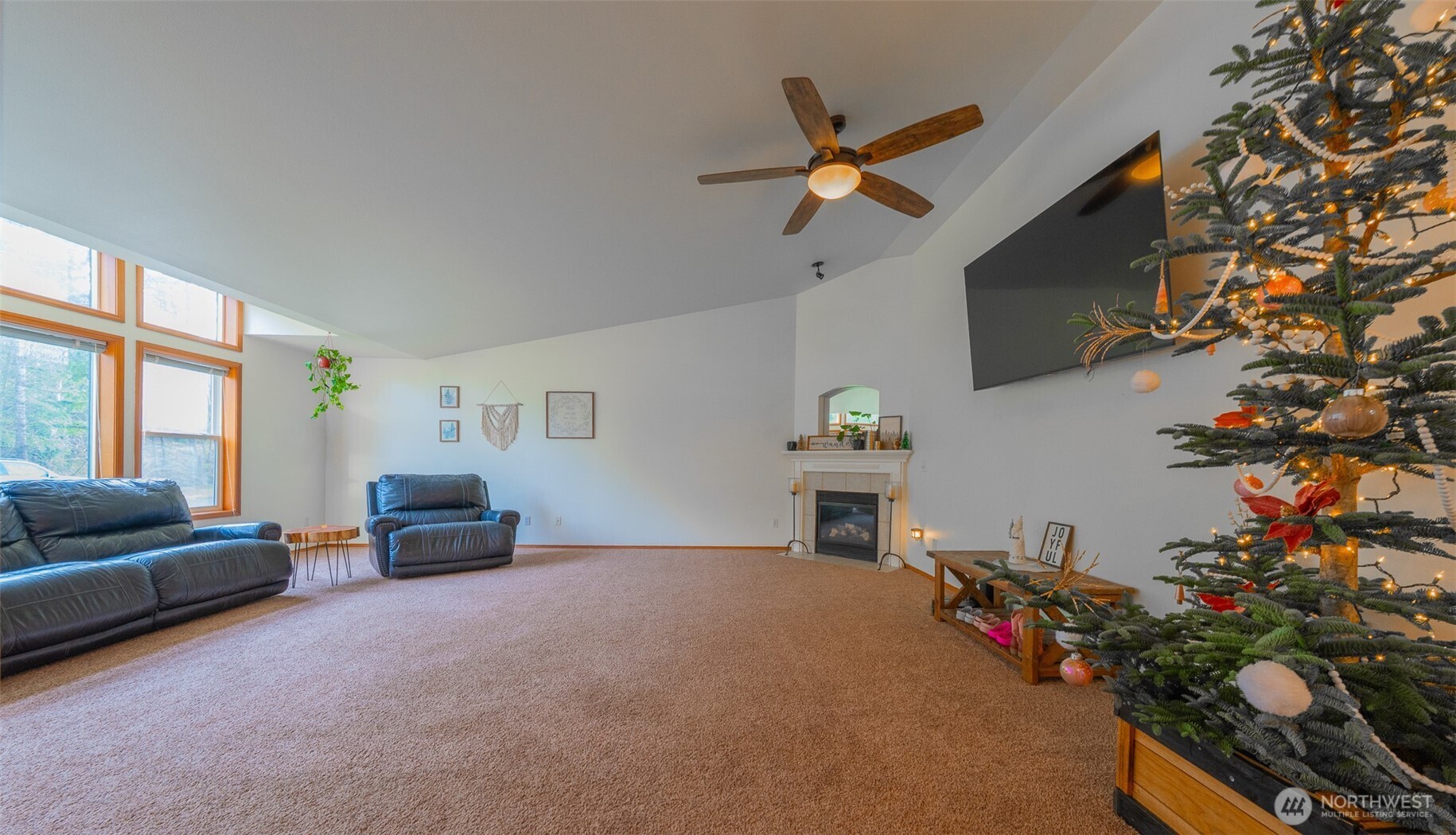 30608 40th Avenue East Graham, WA 98338 - Photo 2 of 30 a living room with furniture and a flat screen tv