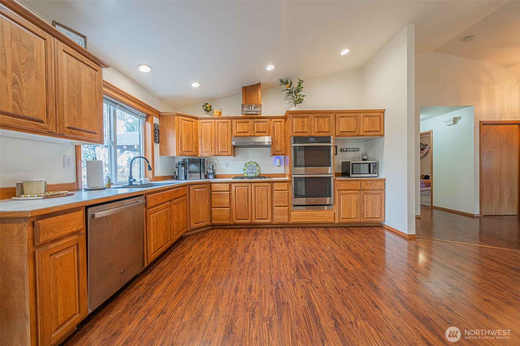 30608 40th Avenue East Graham, WA 98338 - Photo 9 of 30 a kitchen with stainless steel appliances wooden floors and wooden cabinets