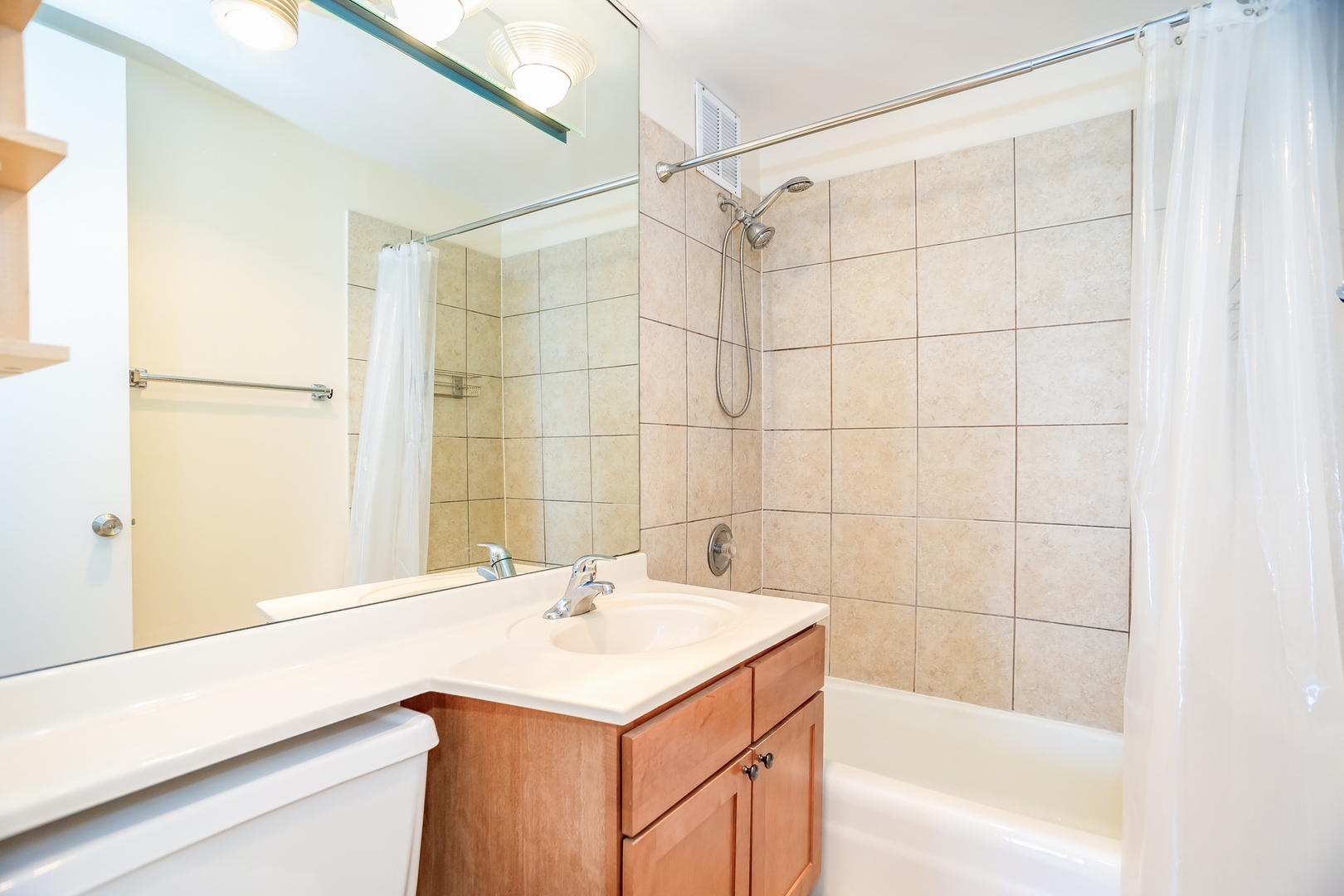 655 West Irving Park Road, Unit 3012 Chicago, IL 60613 - Photo 12 of 24 a bathroom with a sink and a bathtub