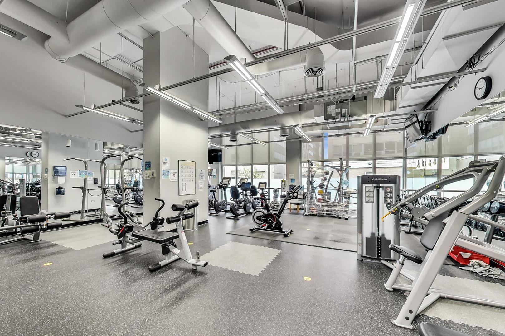 655 West Irving Park Road, Unit 3012 Chicago, IL 60613 - Photo 18 of 24 a view of a room with gym equipment