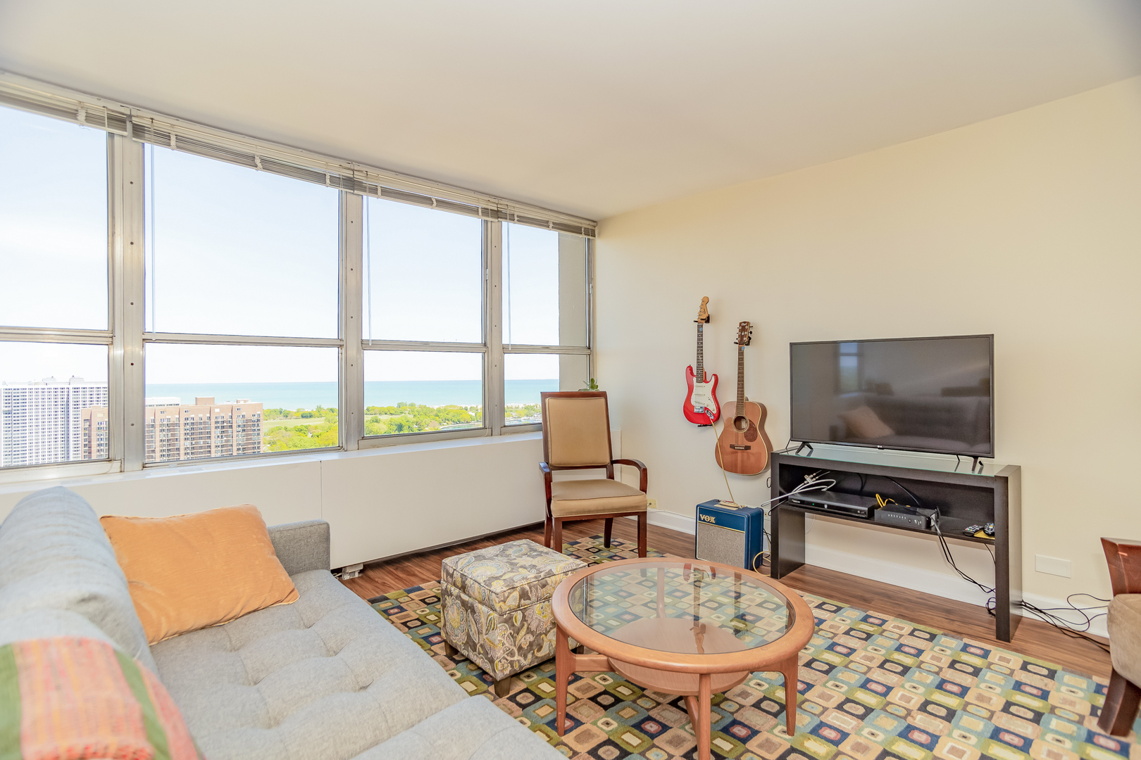655 West Irving Park Road, Unit 3012 Chicago, IL 60613 - Photo 3 of 24 a living room with furniture and a flat screen tv
