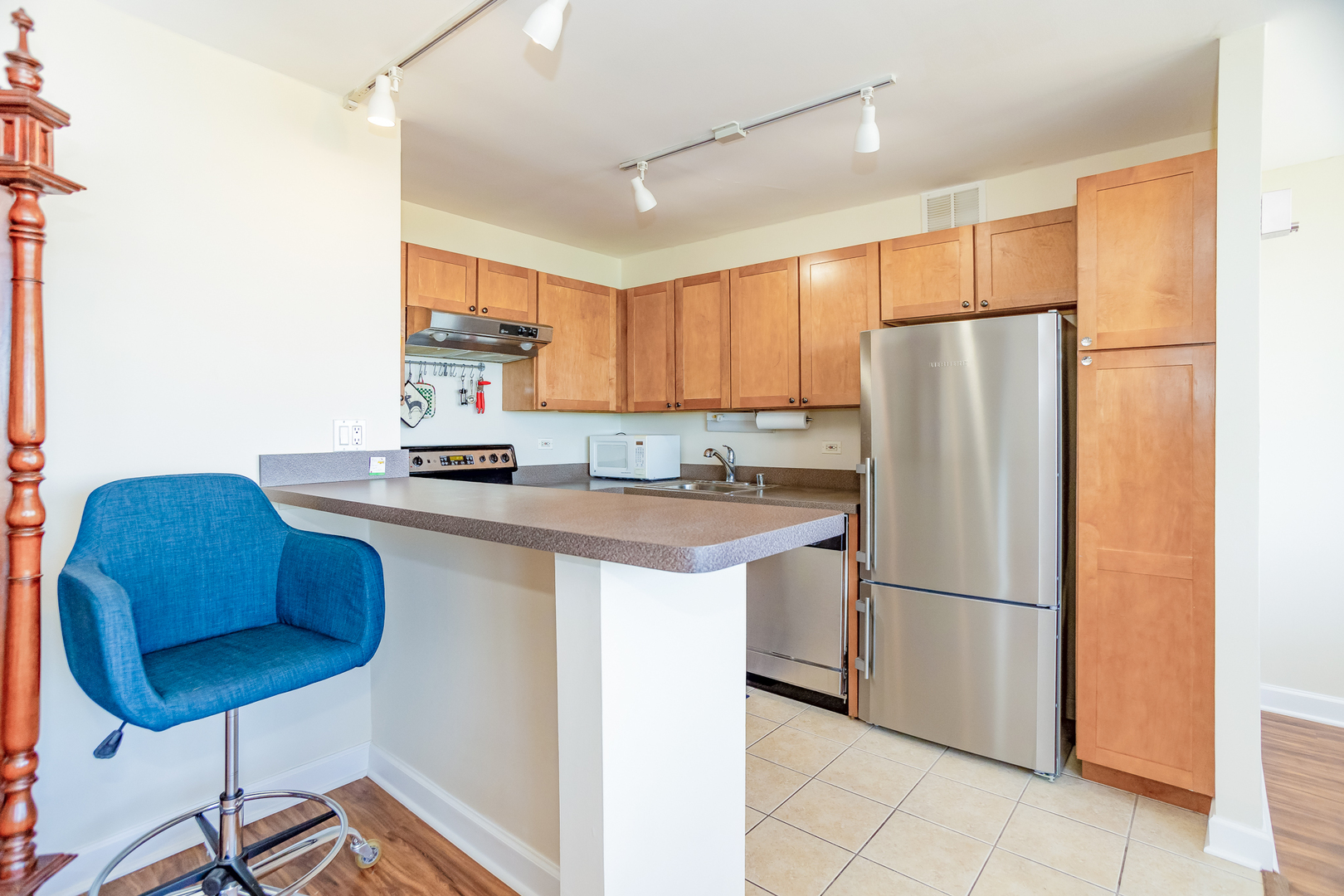 655 West Irving Park Road, Unit 3012 Chicago, IL 60613 - Photo 8 of 24 a kitchen with stainless steel appliances a refrigerator and a stove top oven