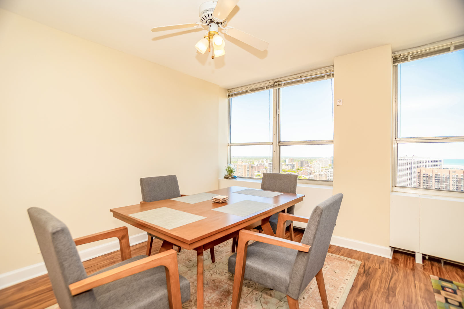 655 West Irving Park Road, Unit 3012 Chicago, IL 60613 - Photo 9 of 24 a view of a dining room with furniture window and wooden floor