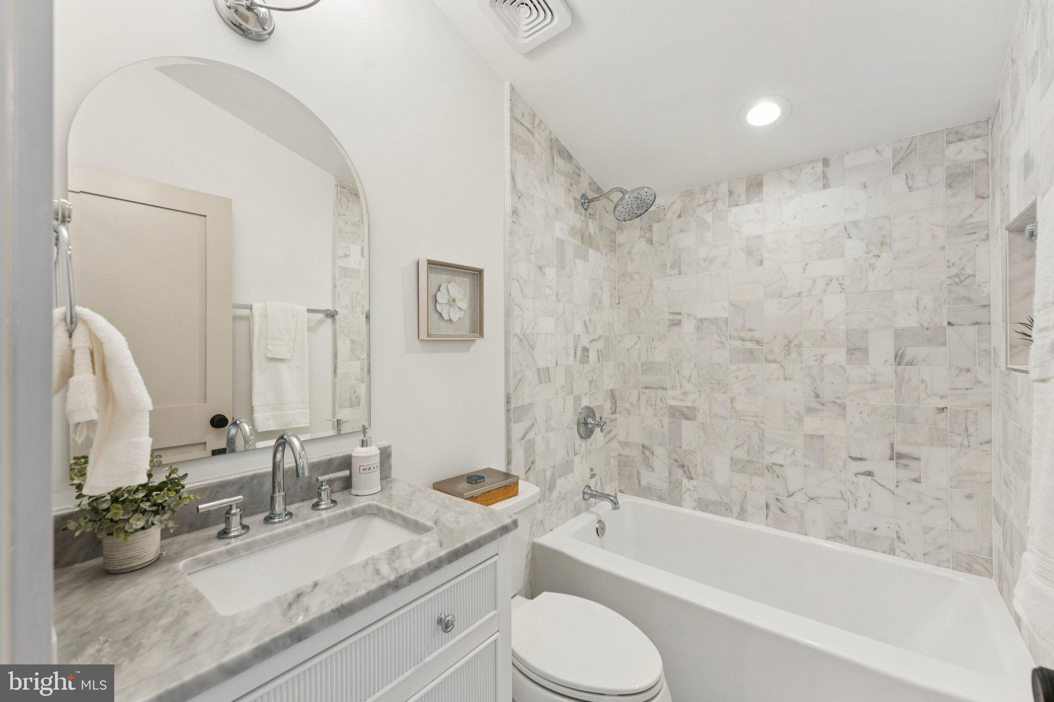 3216 Patterson Street Northwest Washington, DC 20015 - Photo 15 of 34 a bathroom with a granite countertop sink mirror toilet and bathtub