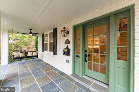 a view of a balcony with wooden floor and windows