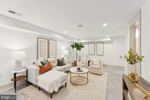 a living room with furniture and flowers