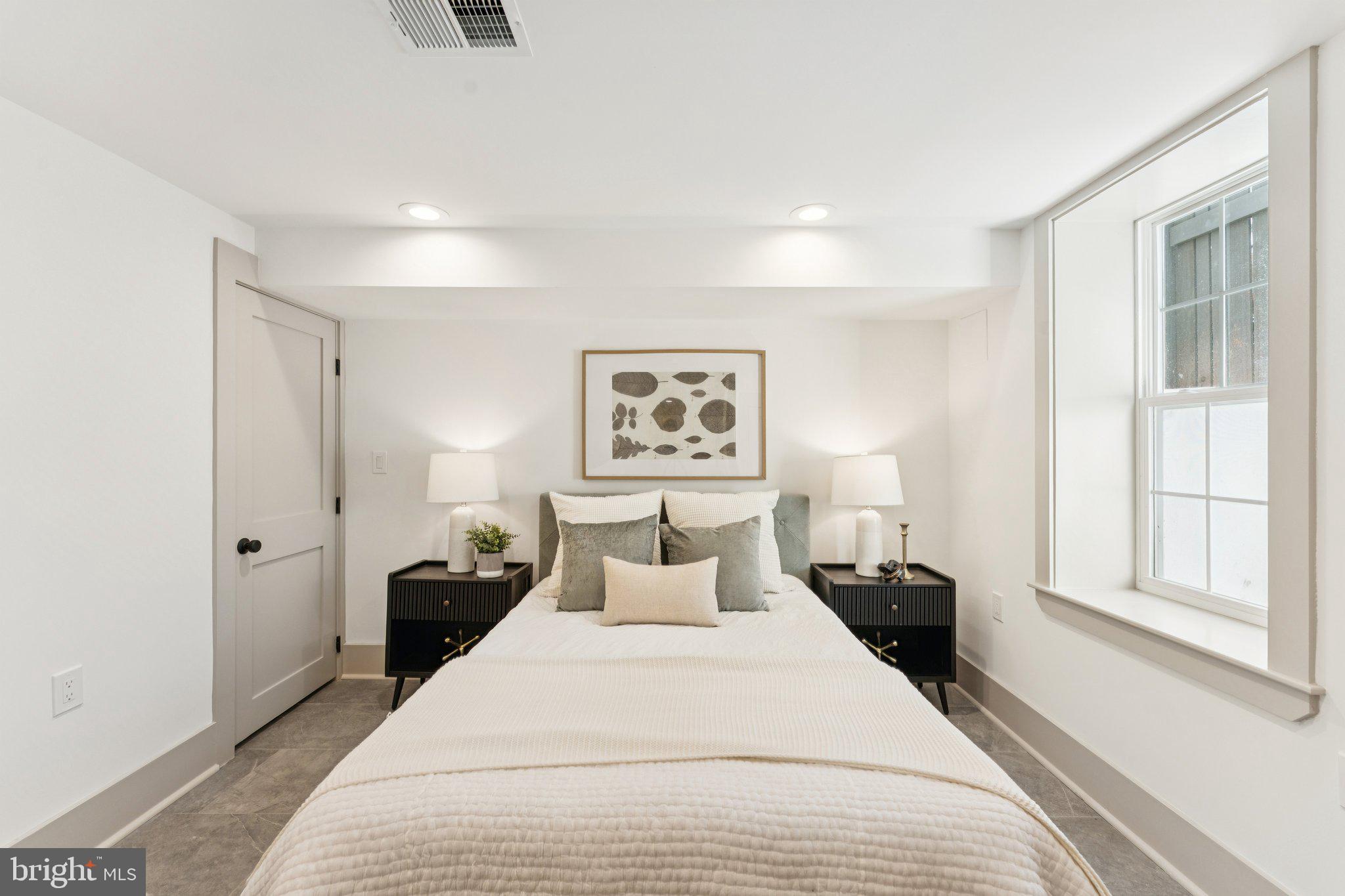 3216 Patterson Street Northwest Washington, DC 20015 - Photo 28 of 34 a bedroom with a bed and a large window