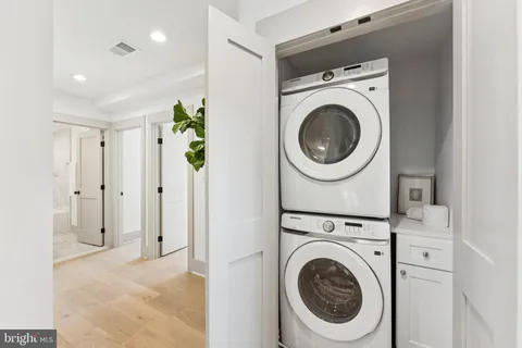 a view of a hallway with washer and dryer