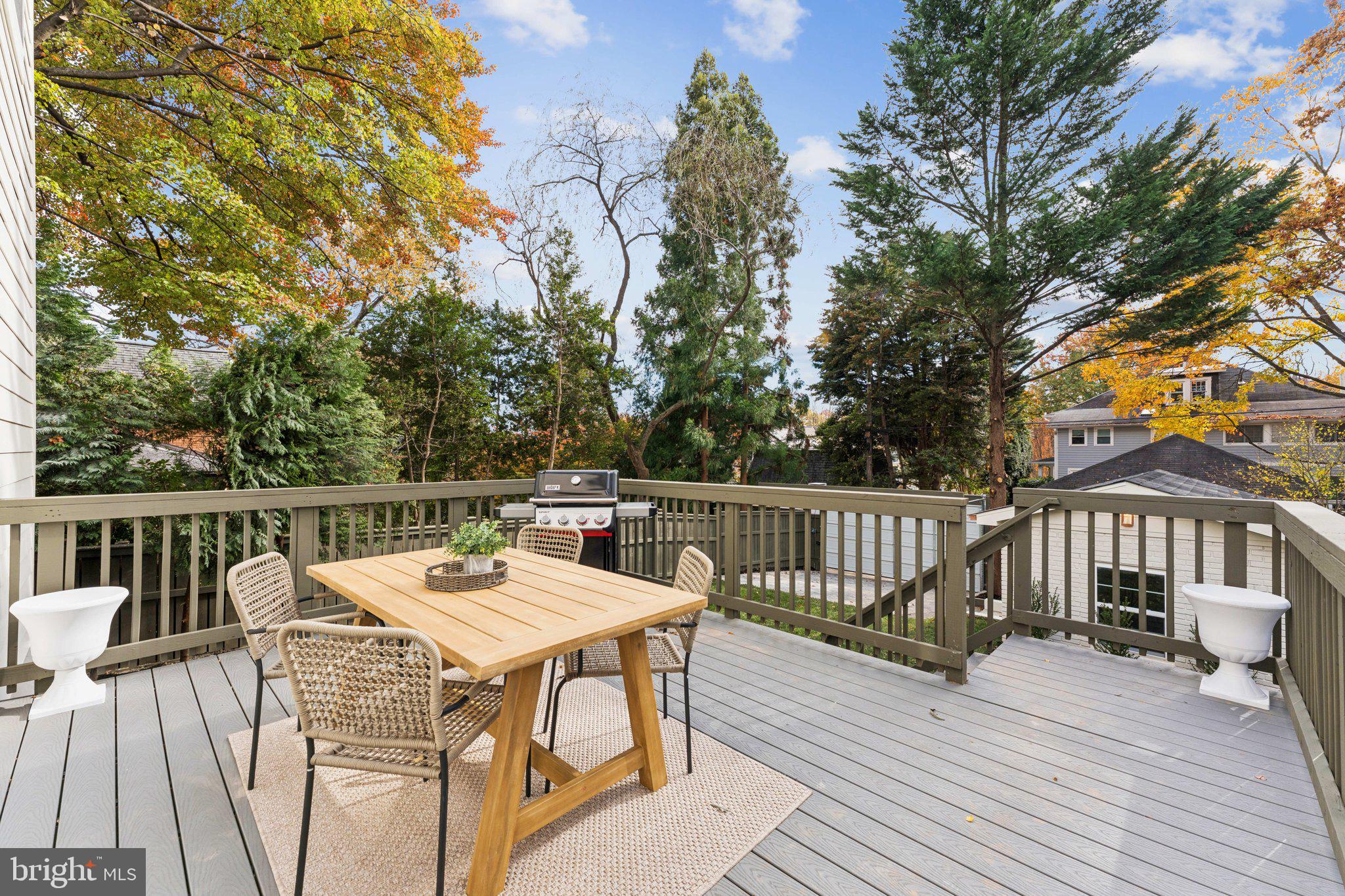3216 Patterson Street Northwest Washington, DC 20015 - Photo 32 of 34 a view of a house with wooden deck and furniture