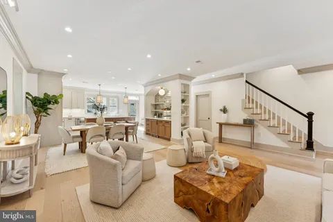 a living room with furniture and a view of kitchen