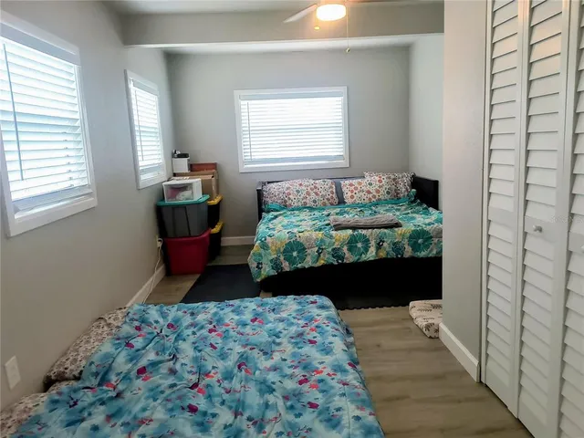 a bedroom with furniture and a large window