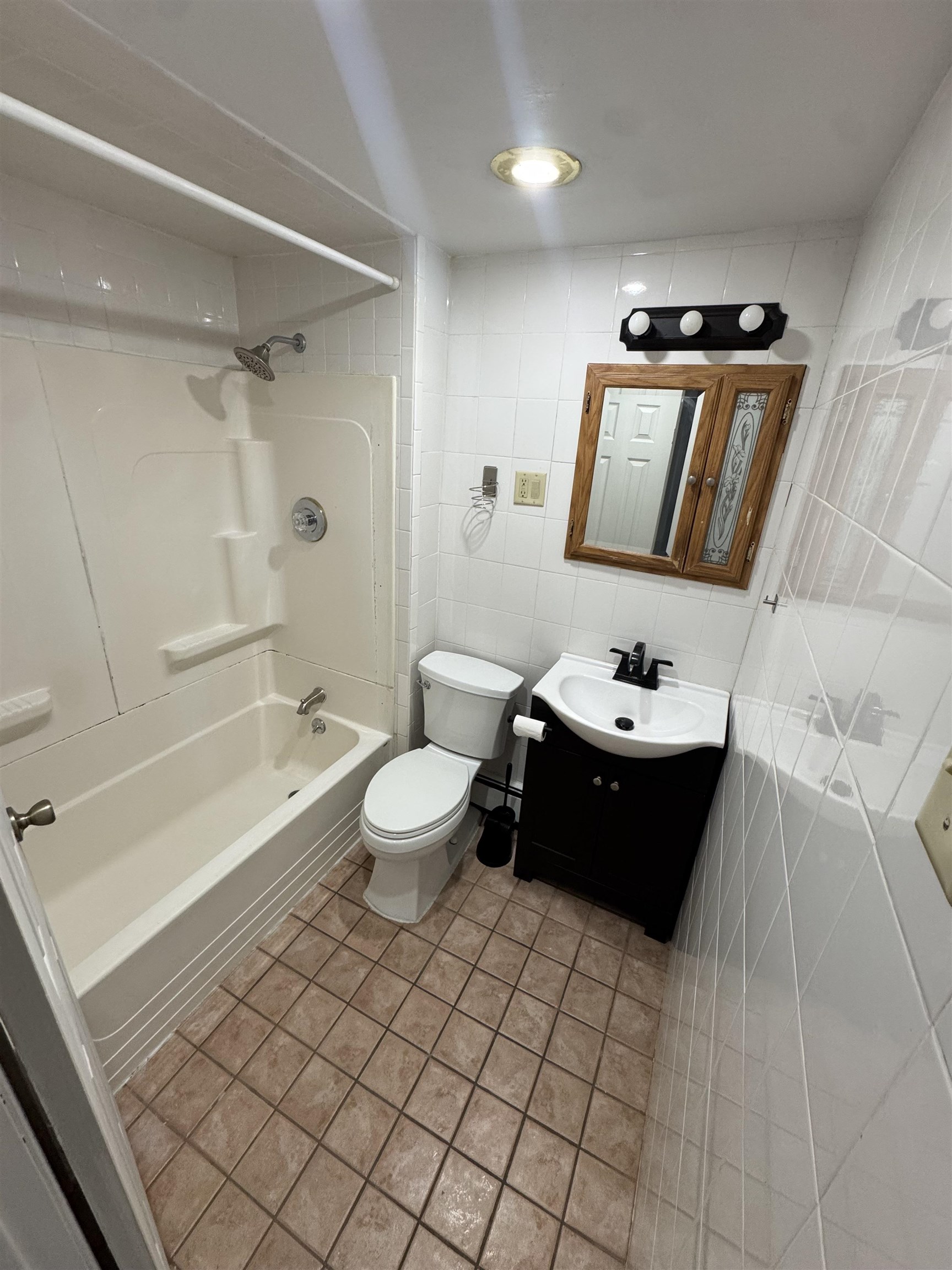 103 Prospect Avenue, Unit 2 Bayonne, NJ 07002 - Photo 12 of 12 a bathroom with a bathtub sink toilet and mirror