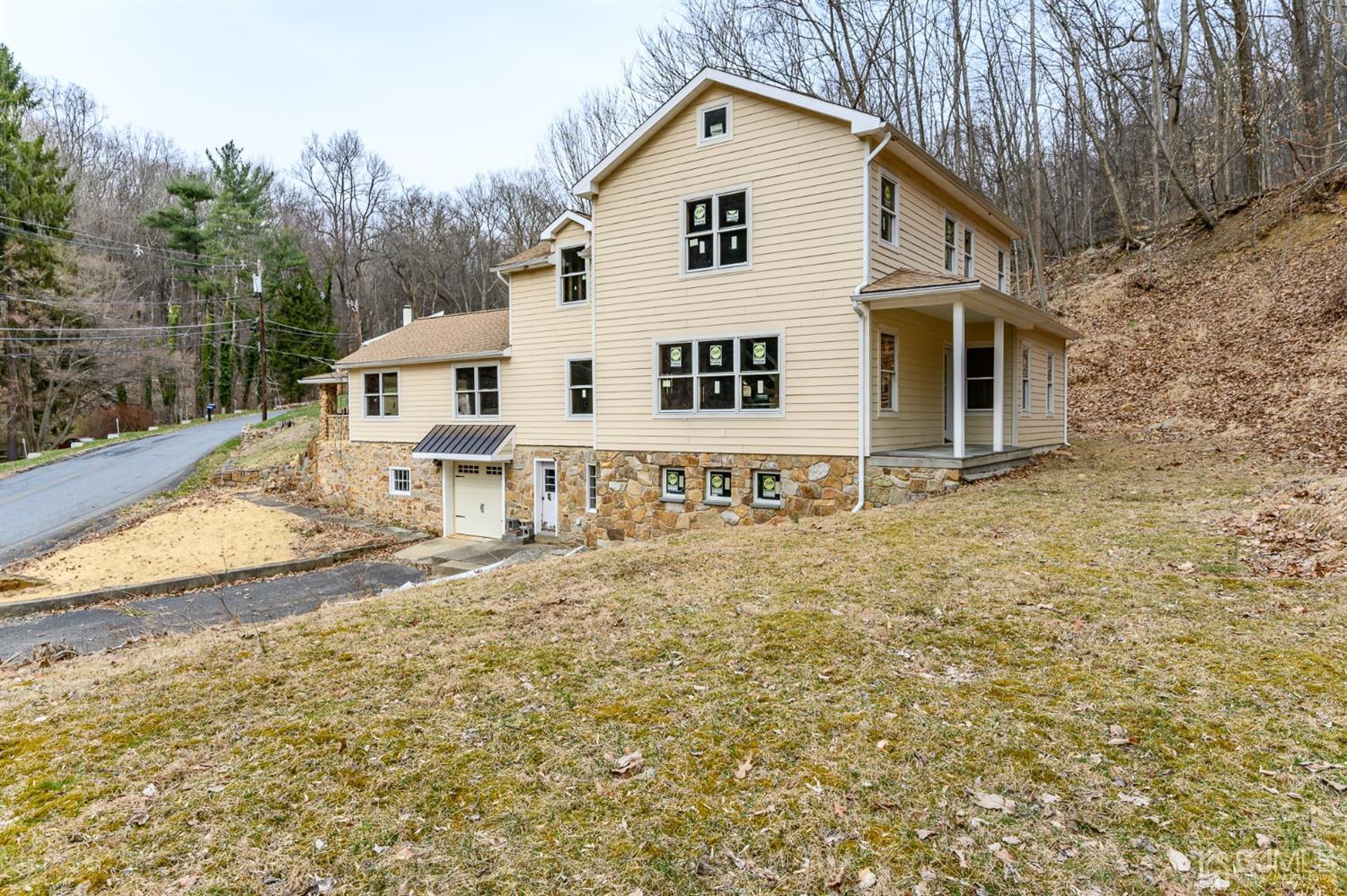 146 Millbrook Road Washington, NJ 07882 - Photo 2 of 25 a view of a white house with a yard
