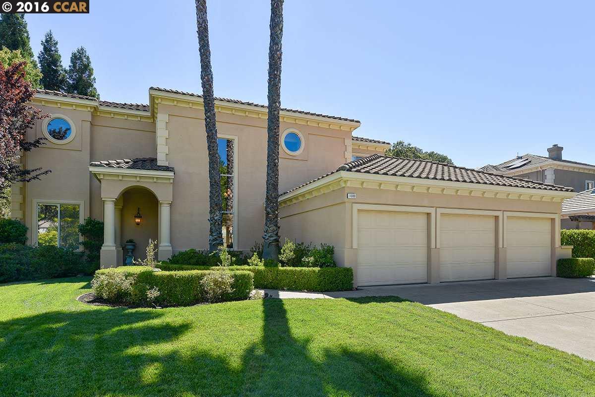 a front view of a house with a garden and plants