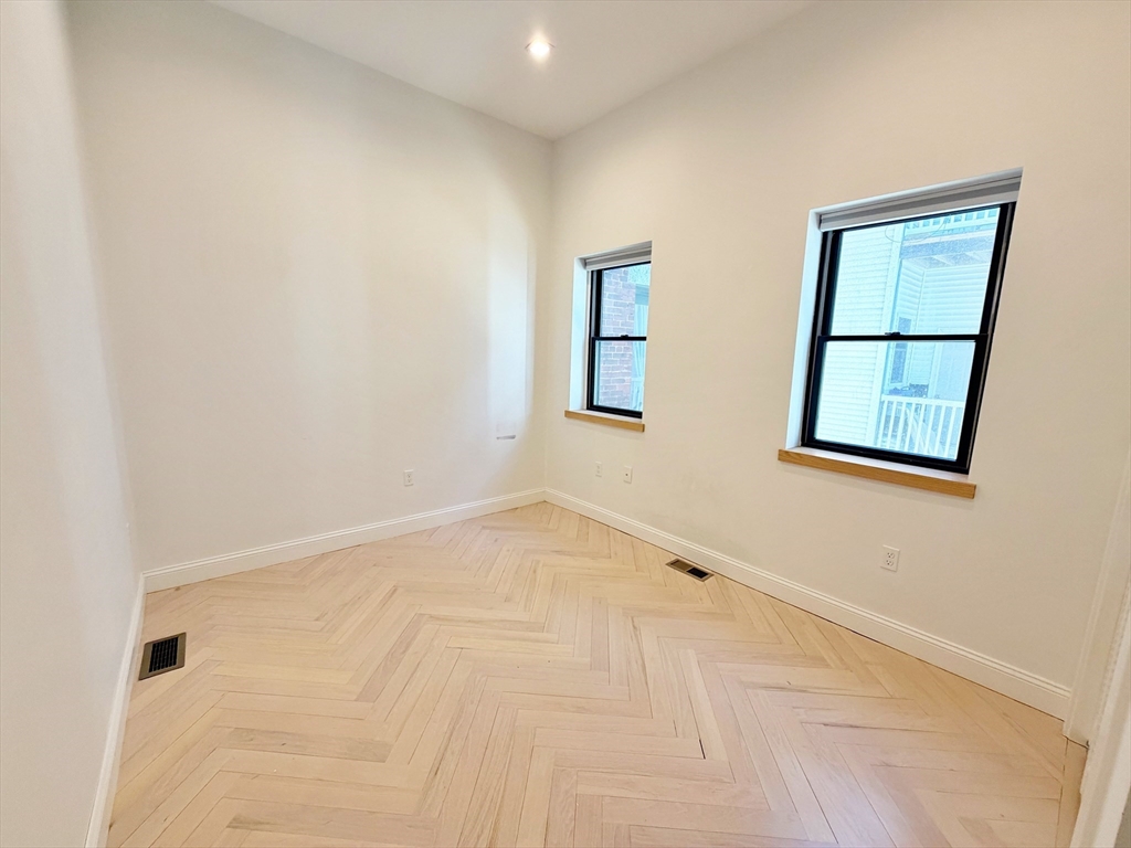 182 Webster Street, Unit 1 Boston, MA 02128 - Photo 19 of 41 an empty room with windows