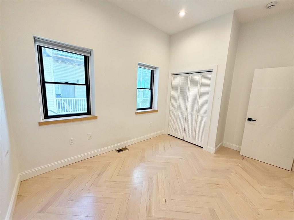 182 Webster Street, Unit 1 Boston, MA 02128 - Photo 20 of 41 an empty room with windows and closet