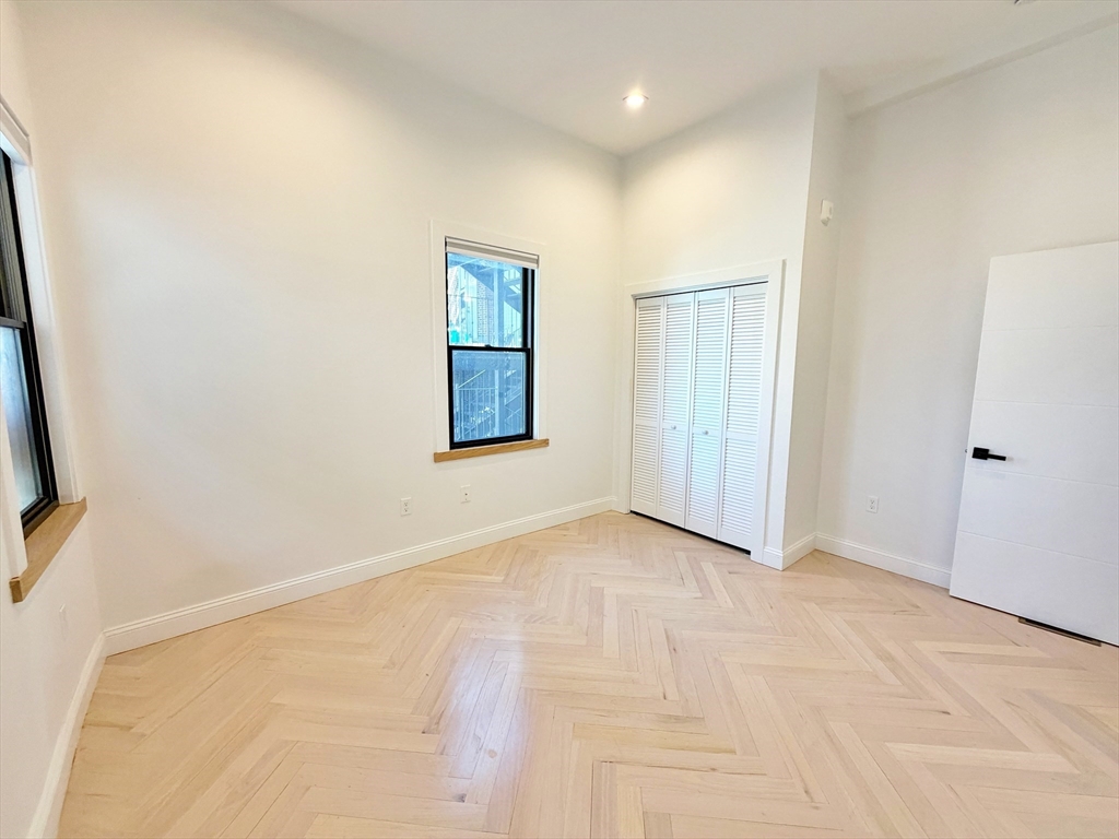 182 Webster Street, Unit 1 Boston, MA 02128 - Photo 25 of 41 an empty room with windows and closet