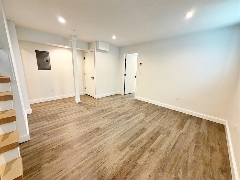 182 Webster Street, Unit 1 Boston, MA 02128 - Photo 28 of 41 an empty room with wooden floor and windows
