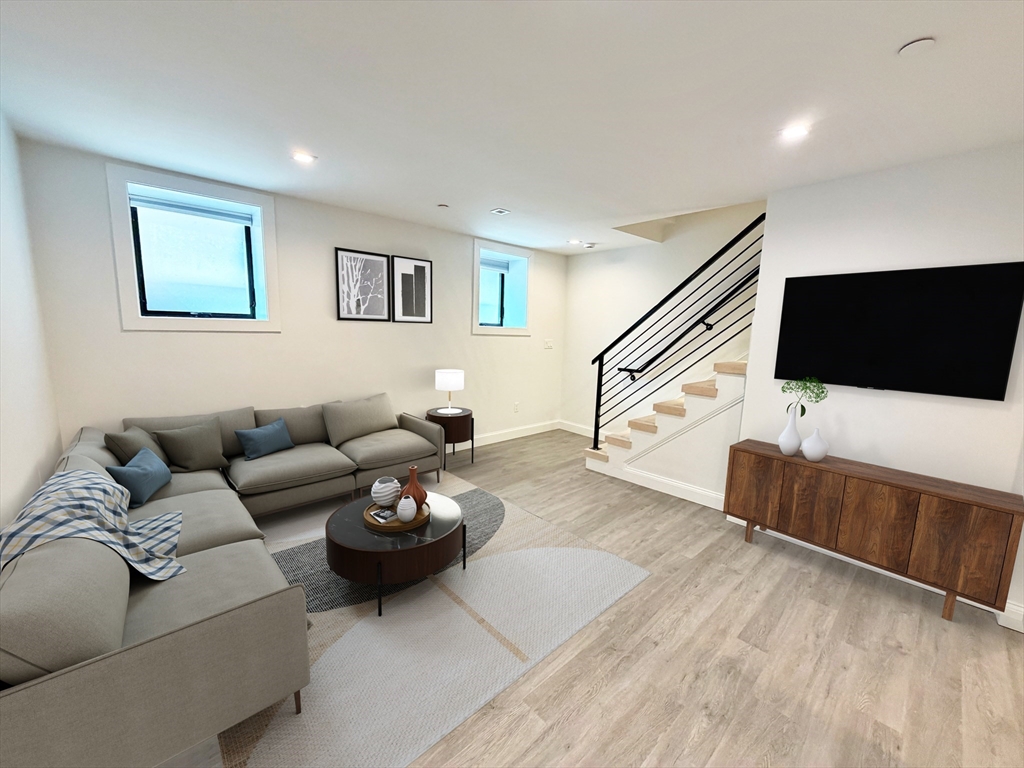 182 Webster Street, Unit 1 Boston, MA 02128 - Photo 3 of 41 a living room with furniture and a flat screen tv