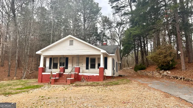 a view of a house with backyard porch and sitting area
