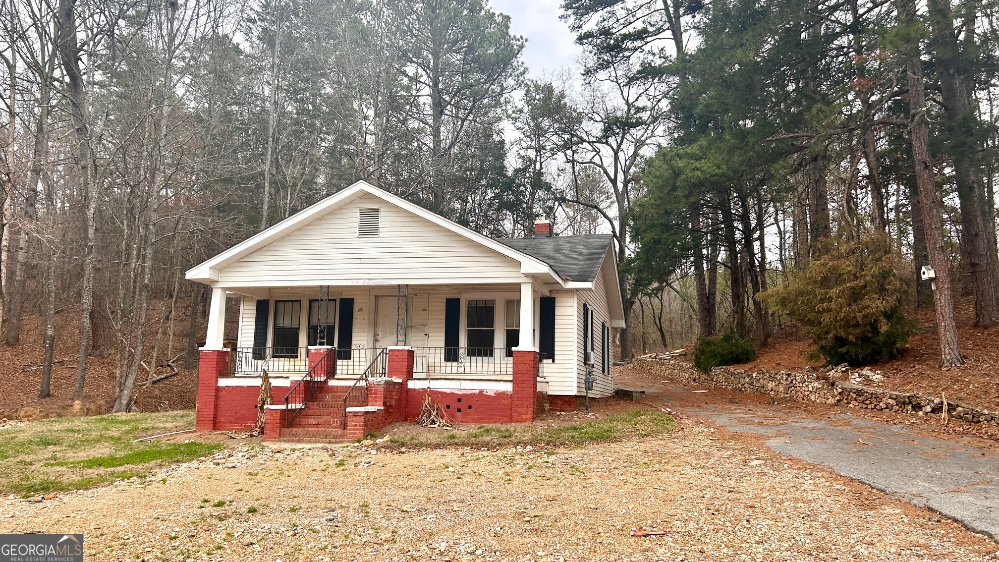 a view of a house with backyard porch and sitting area
