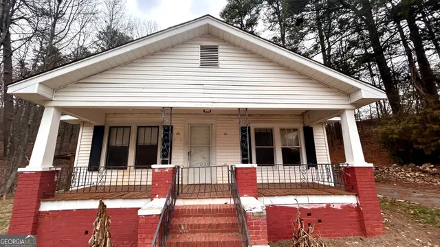 a view of a brick house with large windows