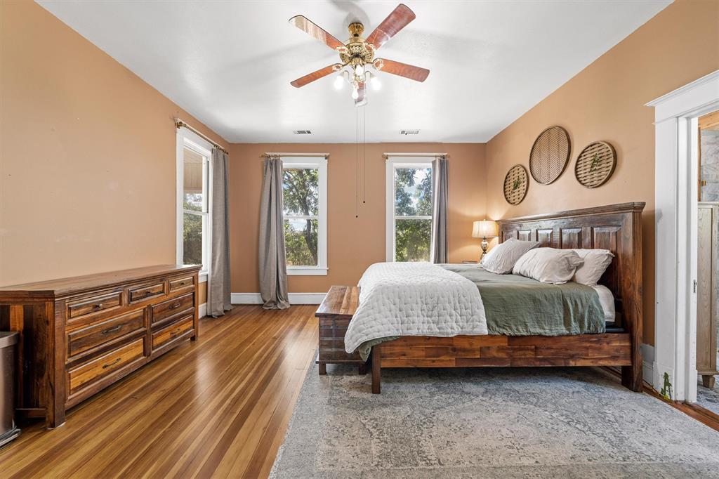 1004 South Old Temple Road Lorena, TX 76655 - Photo 13 of 40 Bedroom with ceiling fan, baseboards, and wood finished floors