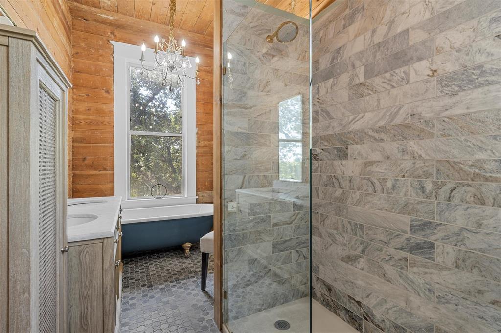 1004 South Old Temple Road Lorena, TX 76655 - Photo 16 of 40 Full bathroom featuring a tile shower, a freestanding bath, a chandelier, and vanity