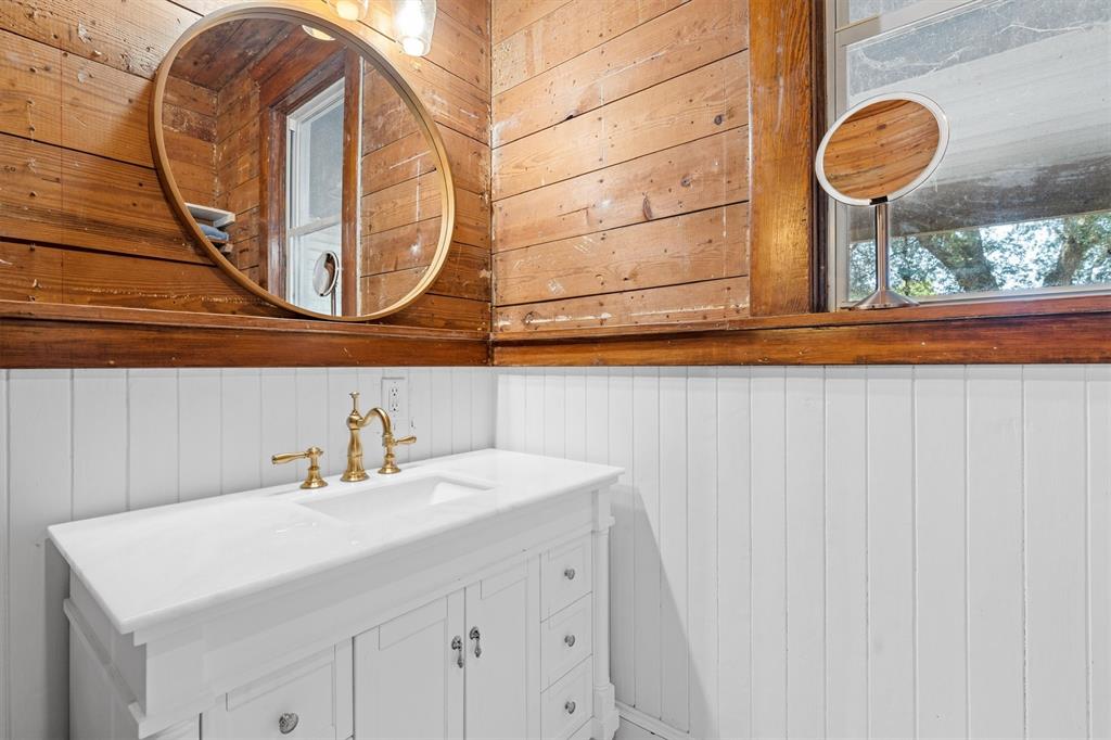 1004 South Old Temple Road Lorena, TX 76655 - Photo 23 of 40 Bathroom with wooden walls and vanity