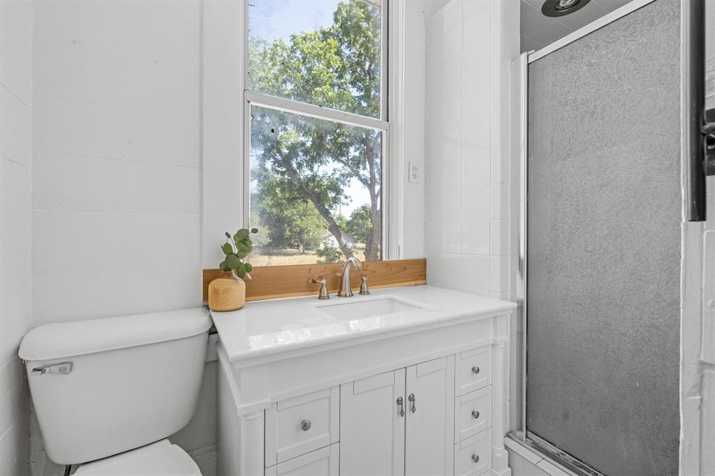 1004 South Old Temple Road Lorena, TX 76655 - Photo 28 of 40 Bathroom featuring toilet, vanity, and a stall shower