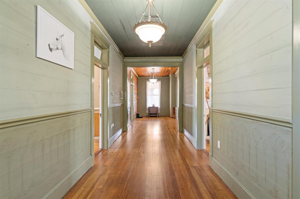 1004 South Old Temple Road Lorena, TX 76655 - Photo 29 of 40 Hallway with wooden walls, ornamental molding, wooden ceiling, and hardwood / wood-style flooring