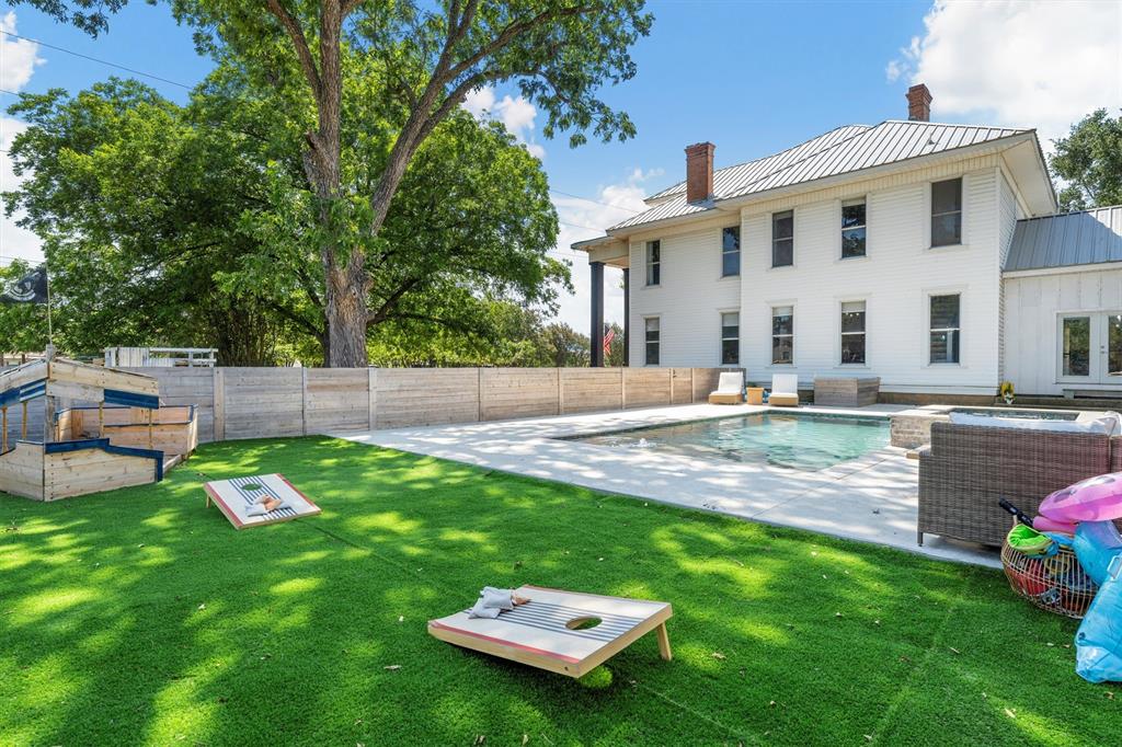 1004 South Old Temple Road Lorena, TX 76655 - Photo 30 of 40 View of swimming pool featuring a jacuzzi, a yard, a fenced backyard, and a patio area