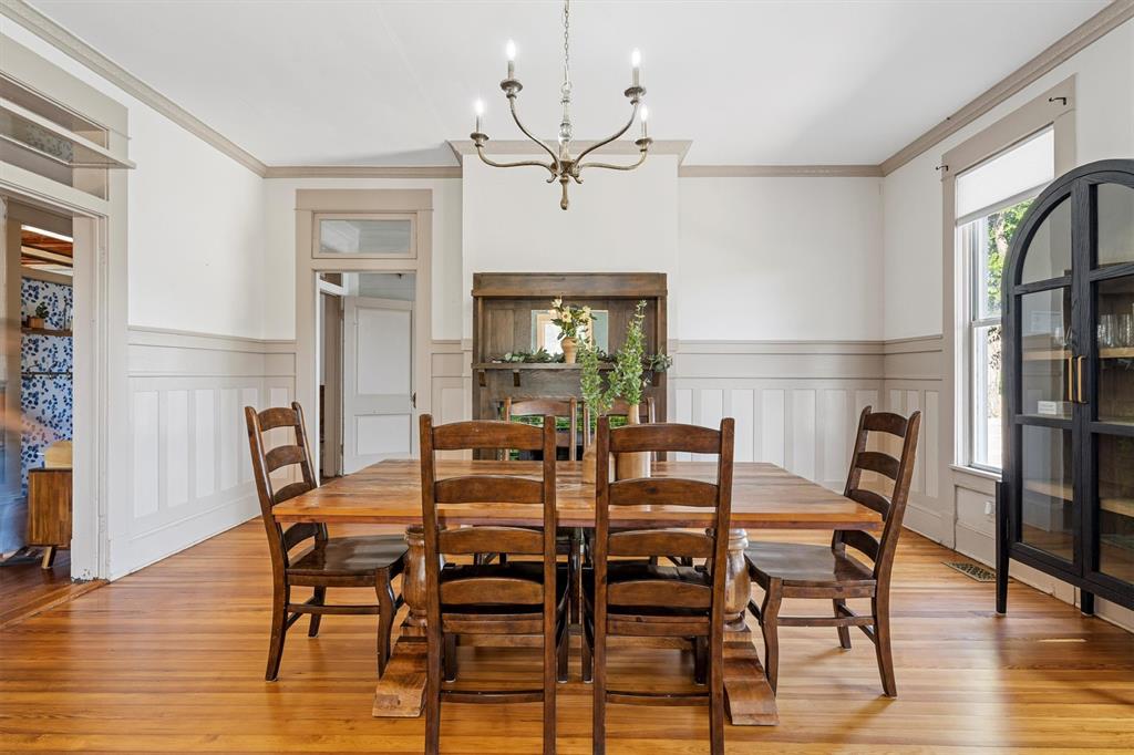 1004 South Old Temple Road Lorena, TX 76655 - Photo 9 of 40 Dining space with crown molding, light wood finished floors, and a notable chandelier