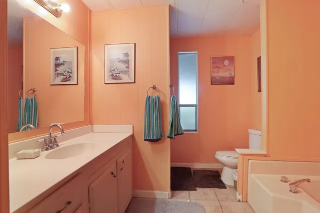 a white bath tub sitting next to a white toilet