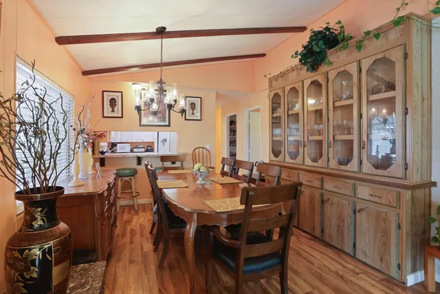 a bedroom with a bed couch and a chandelier