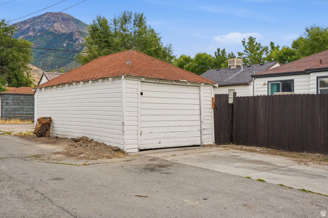 707 East 150 South Provo, UT 84606 - Photo 30 of 31 Detached garage with horizontal white siding and a red shingle roof
