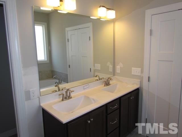 1644 Forest Road Wake Forest, NC 27587 - Photo 13 of 23 Adult height double vanity w/ drawers, matte finish cultured marble tops, MOEN plumbing fixtures
