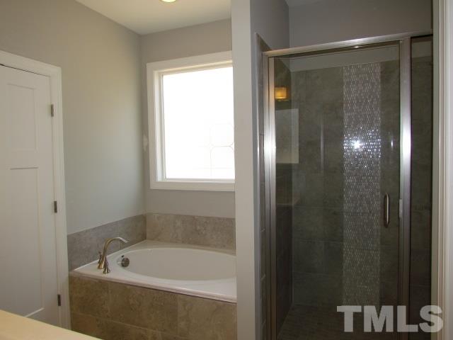 1644 Forest Road Wake Forest, NC 27587 - Photo 14 of 23 Separate garden tub and shower, decorative window to allow for natural light, tile floor