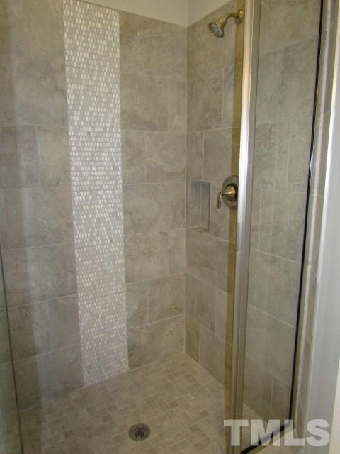 1644 Forest Road Wake Forest, NC 27587 - Photo 15 of 23 Tile shower w/ accent, MOEN plumbing fixtures, glass enclosure