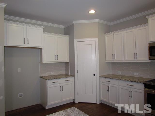 1644 Forest Road Wake Forest, NC 27587 - Photo 6 of 23 Gorgeous 42" white painted kitchen cabinets with dark gray island. Walk in pantry