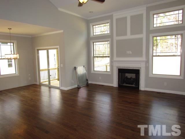 1644 Forest Road Wake Forest, NC 27587 - Photo 10 of 23 Open living room w/ tons of natural light, site finished hardwood floors, ceiling fan w/ light, gas log fireplace