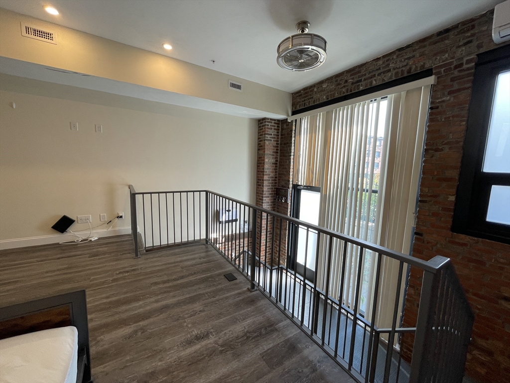 1028 Commonwealth Avenue, Unit 102 Boston, MA 02215 - Photo 8 of 11 a view of a hallway with wooden floor
