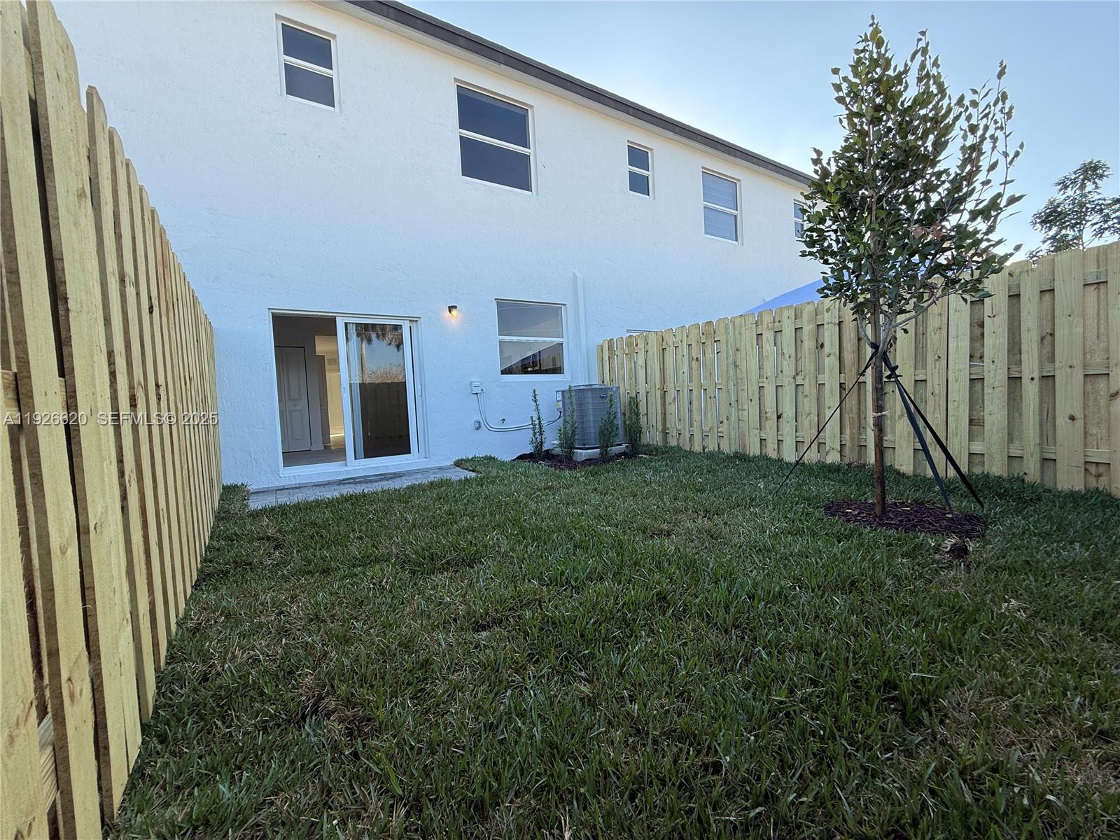 26846 Southwest 121st Court Homestead, FL 33032 - Photo 13 of 37 a view of a house with backyard and a tree