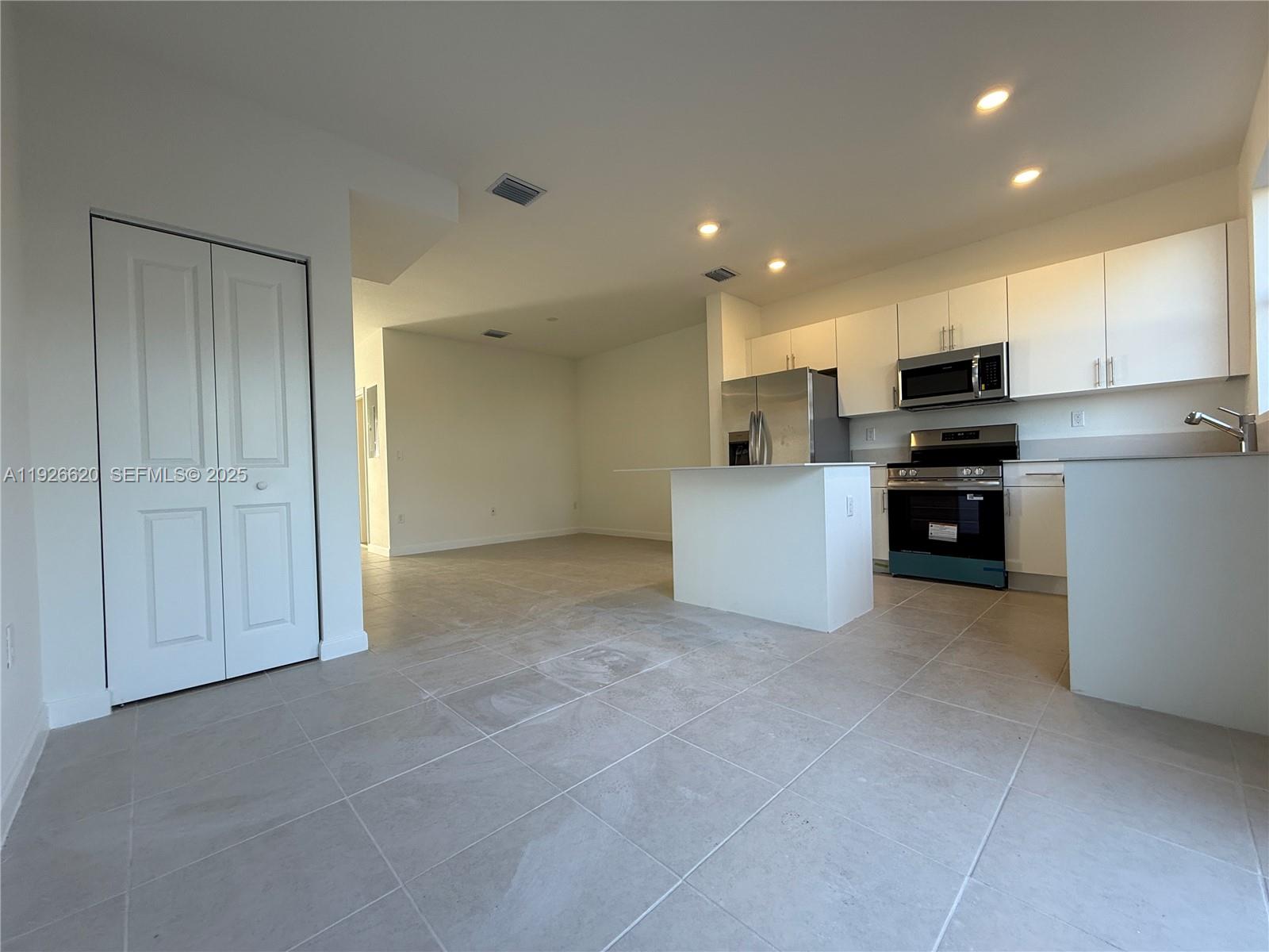 26846 Southwest 121st Court Homestead, FL 33032 - Photo 14 of 37 a view of kitchen and refrigerator cabinets